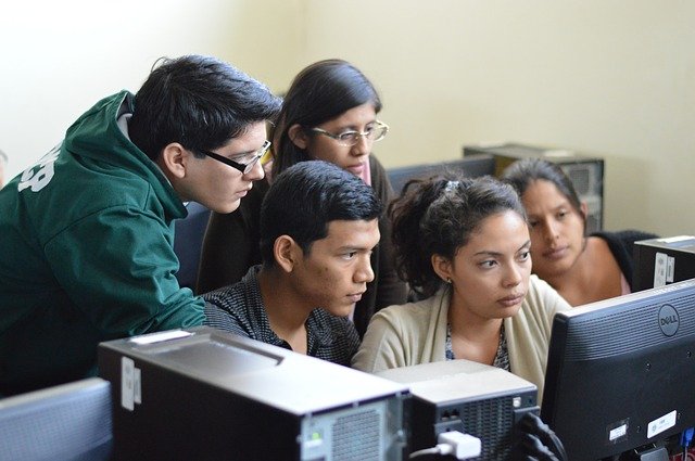 Student Group watching computer for career information.